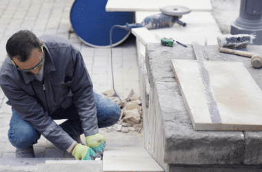 Image of a man installing a masonry walkway for those looking to start your outdoor service business.